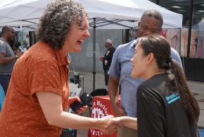 Courtney Bryan shaking hands with staff at the 10th anniversary event of Brooklyn Justice Initiatives