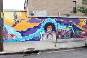 Wide shot of community mural at the Marcus Garvey Apartments in Brownsville.