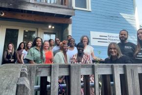 Outdoor group shot of Executive Director Courtney Bryan with the Center’s Syracuse team