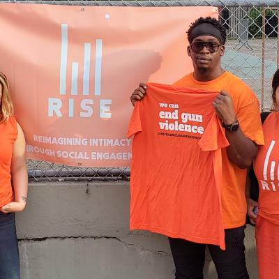 RISE Project staff in orange t-shirts