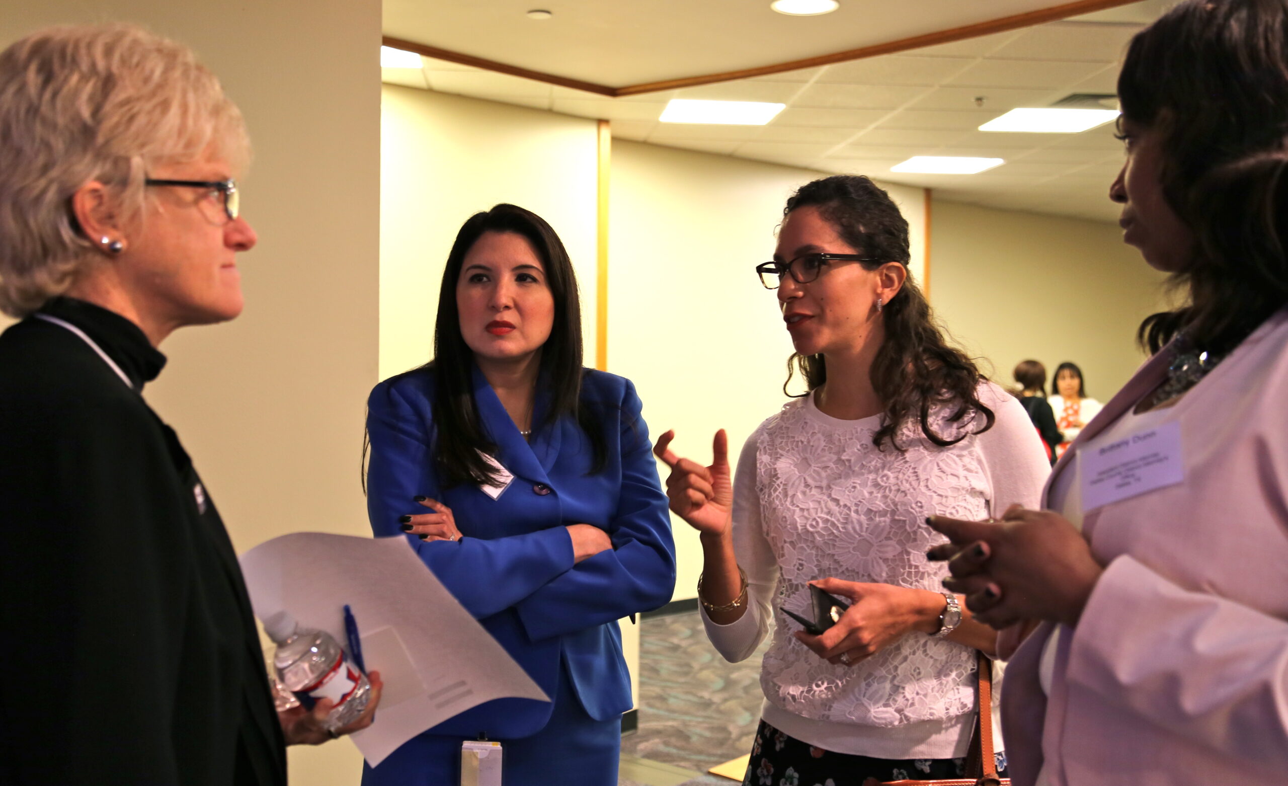 Summit attendees speak to Penny Rayfield (left) from the Texas Association of Business.