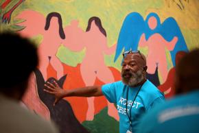 artist/facilitator describing painting on the wall to the group, Project Reset at the Brooklyn Museum.
