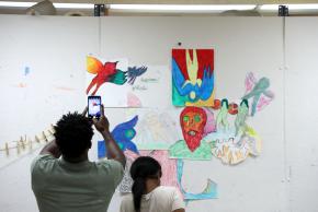 Project Reset participants sharing their artwork on the wall during a workshop in Brooklyn