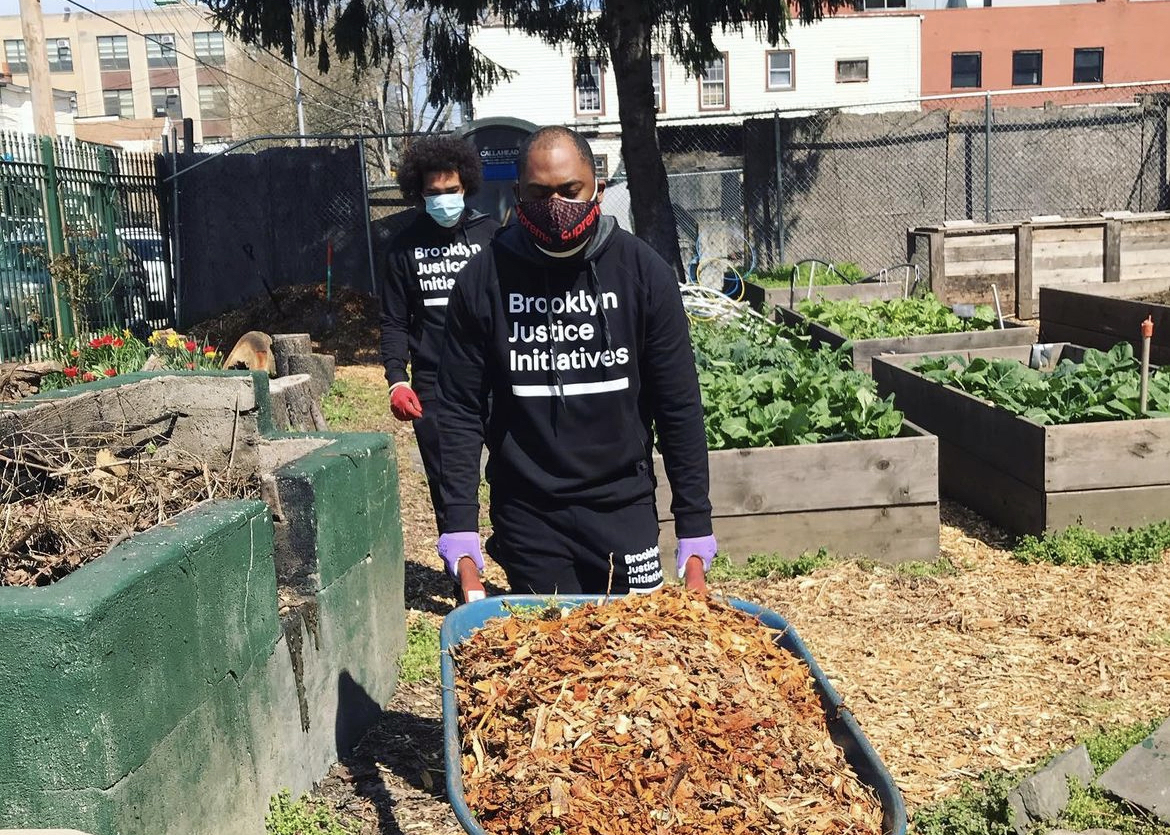 Brooklyn Justice Initiatives staff doing community service during COVID, cleaning up garden