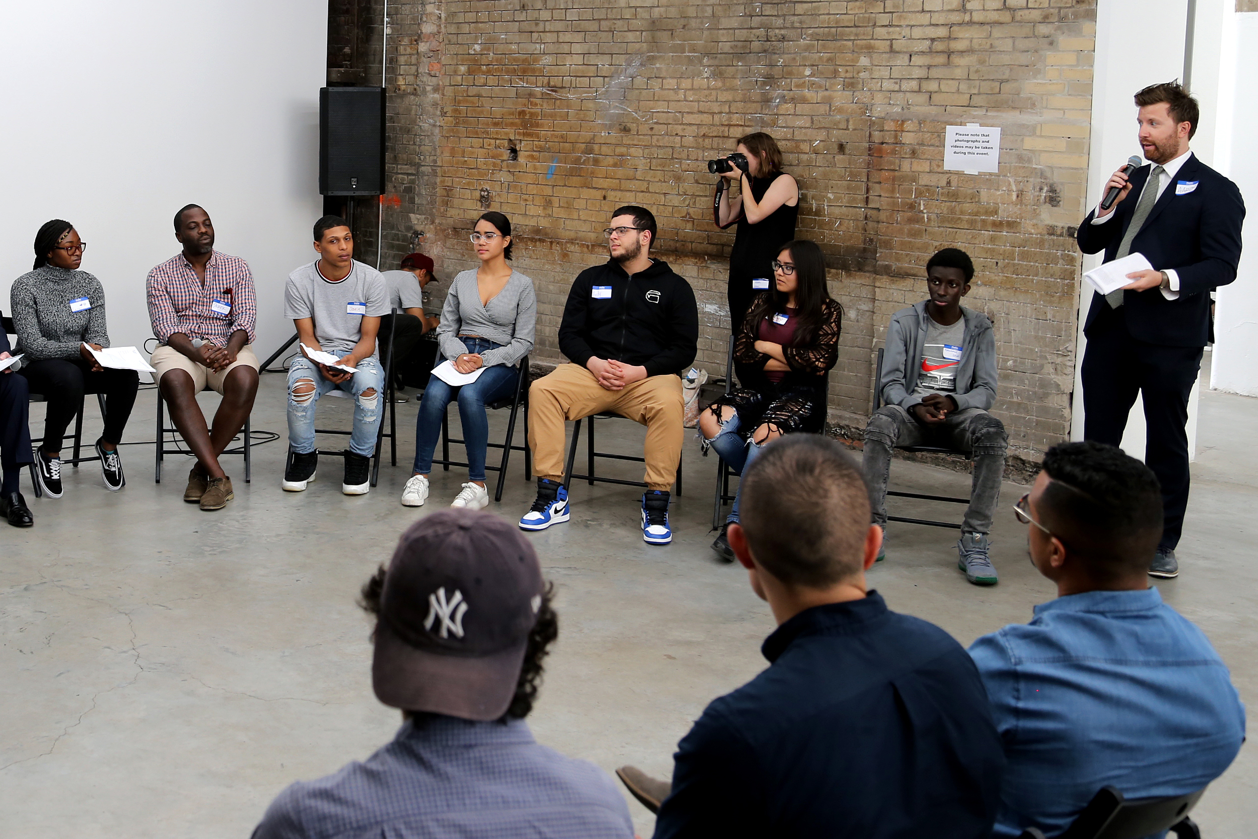 Project Reset group sitting in a circle with Project Reset teaching artist Derek Fordjour at event