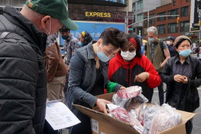 Community First staff giving out free supplies to community members in the Times Square area