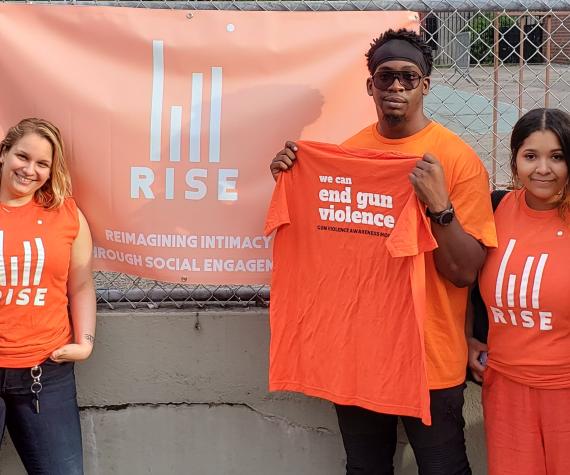 RISE Project staff in orange t-shirts