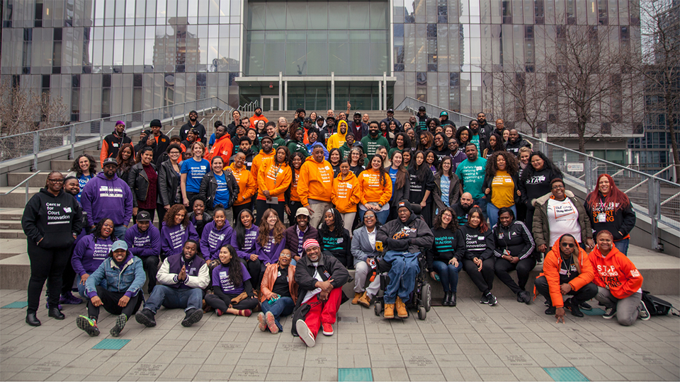 Center for Justice Innovation staff pose for a group photo on outdoor steps