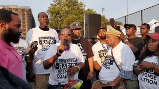 Alicka Ampry-Samuel speaks into microphone as part of the Brownsville Rapid Response Coalition 