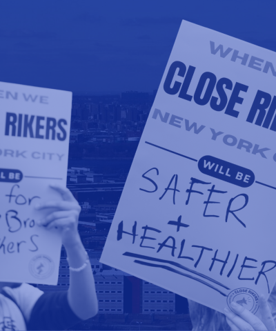 Signs that say "Close Rikers"