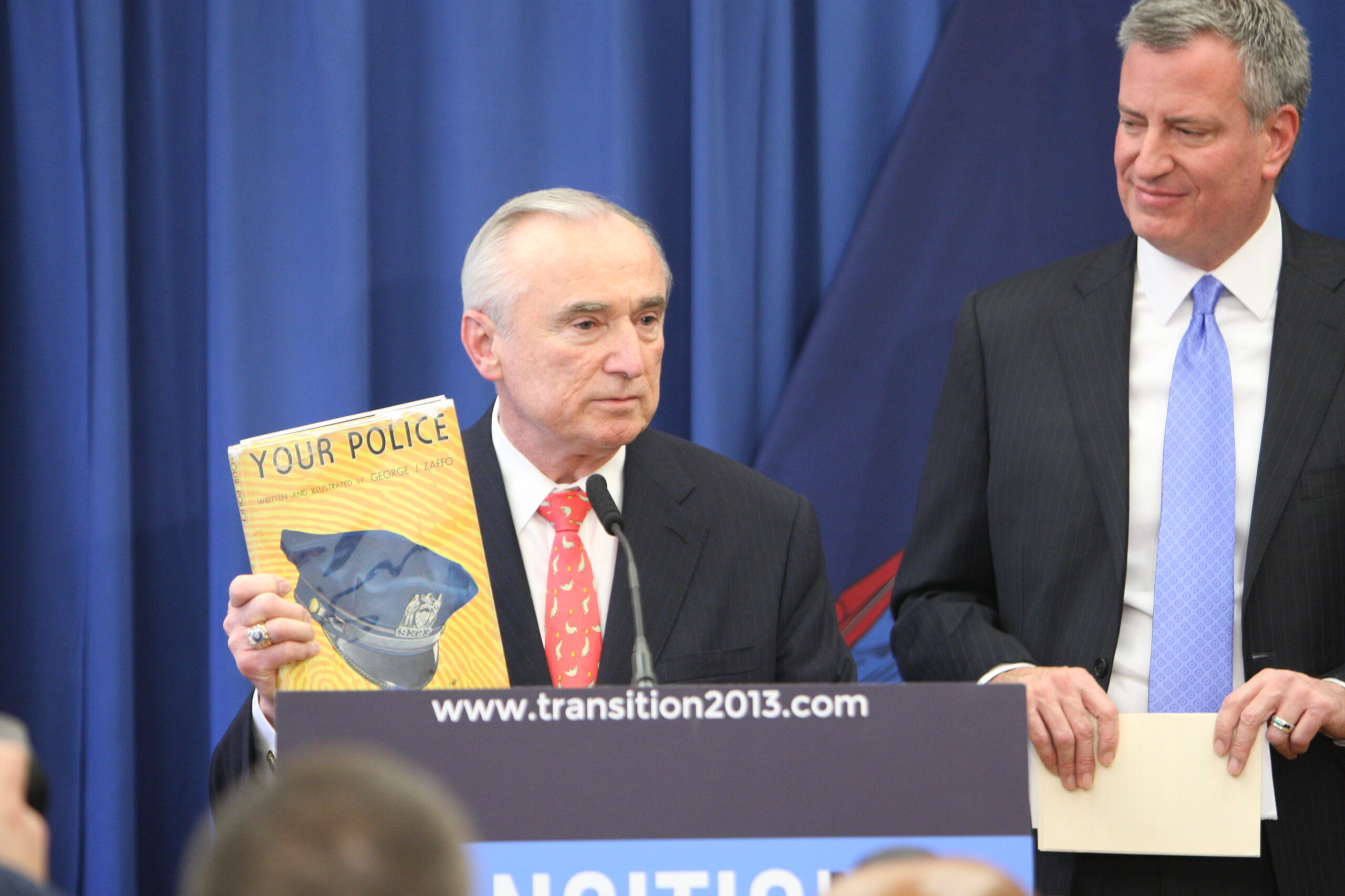 William Bratton holds up a children's book that he borrowed from the Boston Public Library when he was 9 years old. He said it inspired him to become a police officer.