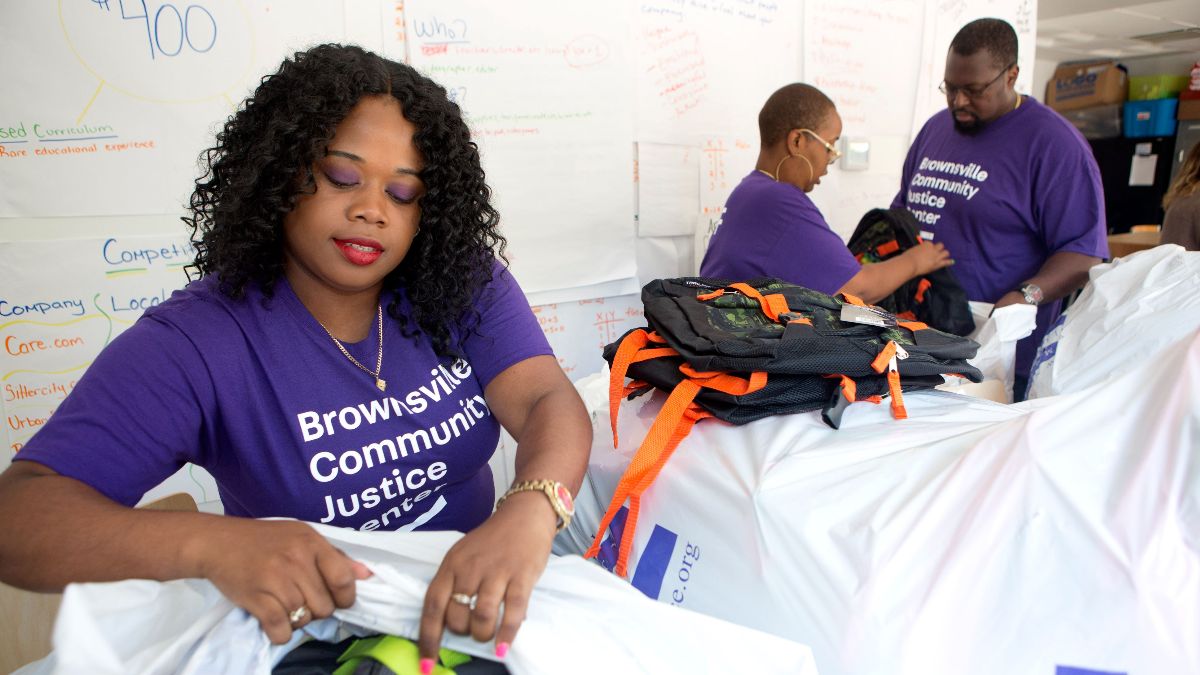 Brownsville Community Justice Center Staff working event packing care bags for the community