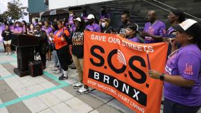 SOS Bronx outside with their banner at a community event