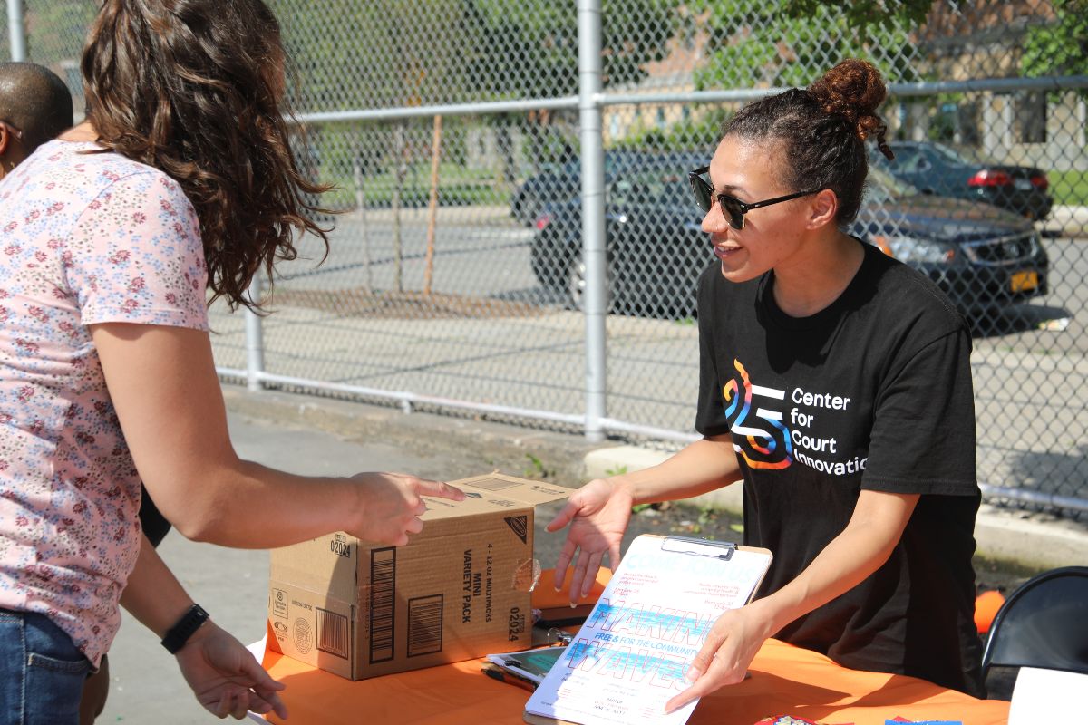 Staff speaking to a community member about the importance of safety