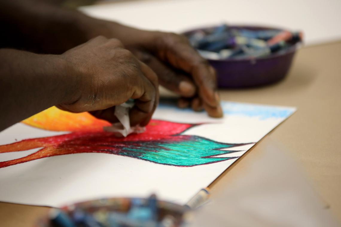 close-up of participant's hands creating artwork at the table during a Project Reset workshop at the Brooklyn Museum