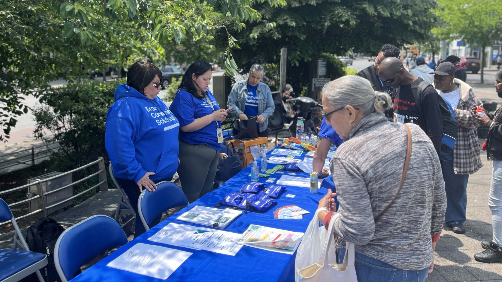 Our Bronx HOPE team sets up a table with overdose prevention kits and informational packets.