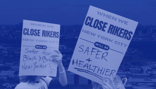 Signs that say "Close Rikers"