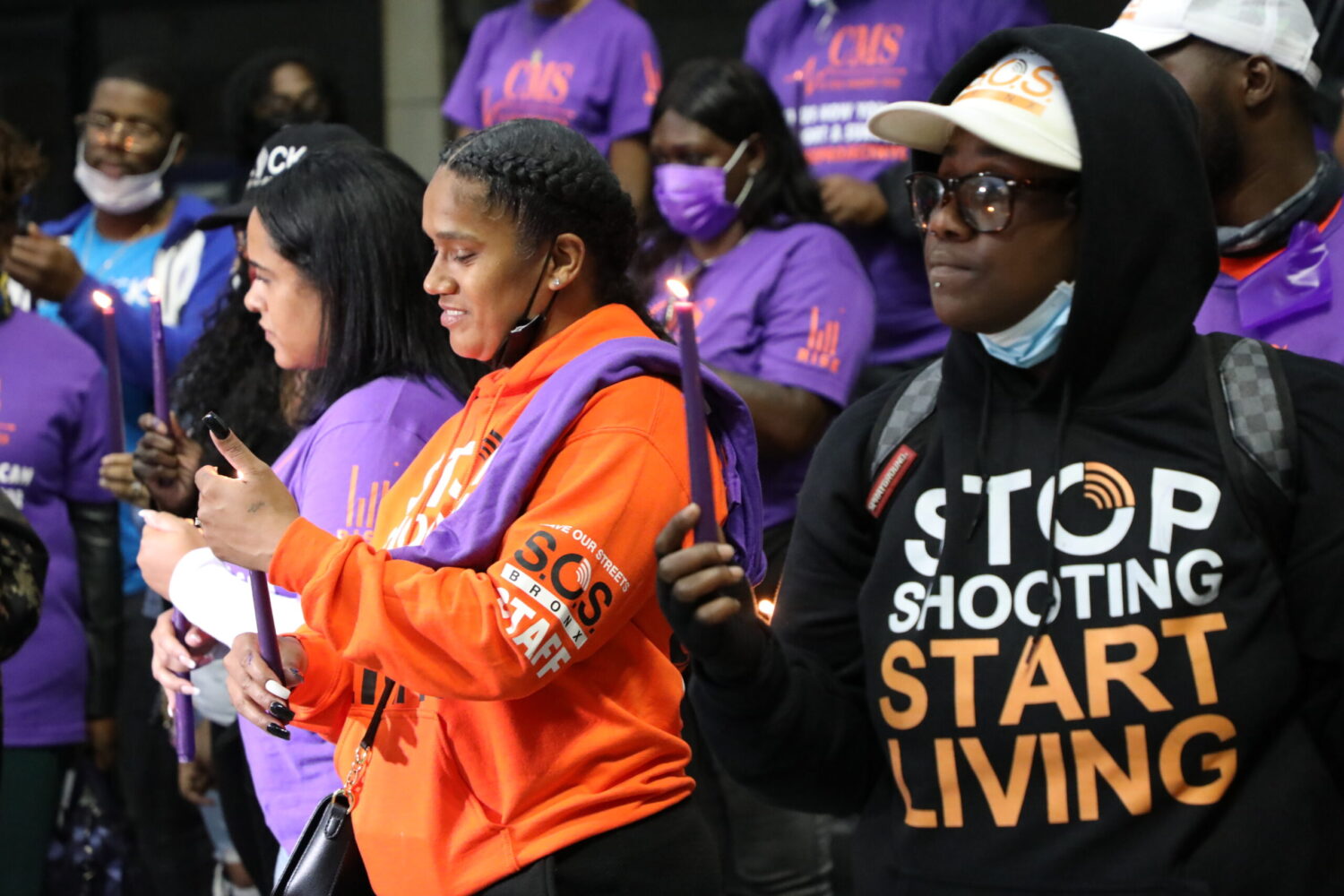 RISE and S.O.S. staff lighting candles for victims of gun and domestic violence.