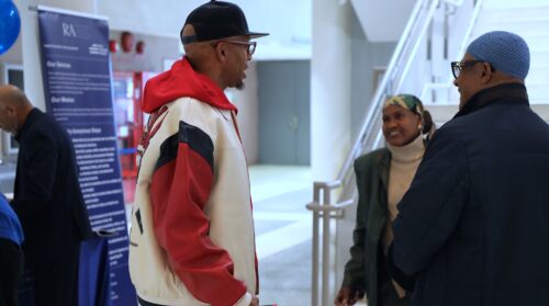 Three people standing having a conversation at Bronx Community Solutions' reentry resource fair.