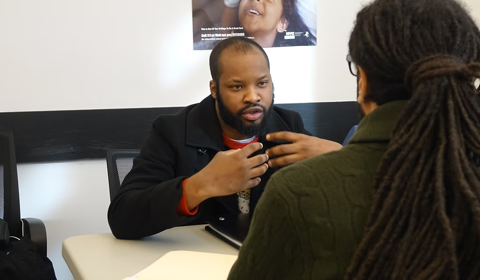 A Project Reset team member speaks with a client