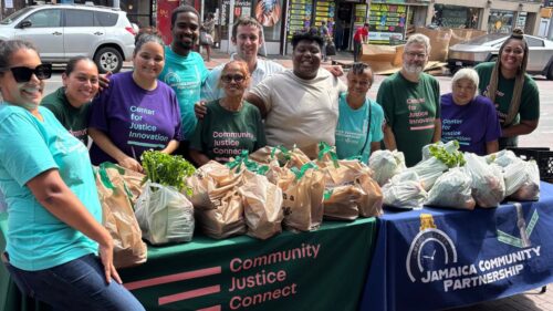 Community Justice Connect volunteers pose for a picture at a pop-up pantry