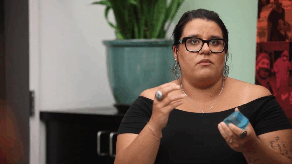 Jennifer Gil Vinueza, Senior Program Manager of Restorative Practices at the Center, speaks while holding a blue talking-piece in a restorative justice circle.