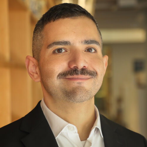 Headshot of Jeremy Madrid in collared shirt and blazer