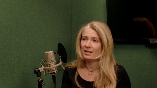 Emily Galvin Almanza speaks into a microphone in a recording studio.