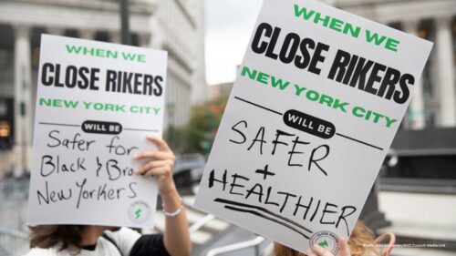 Protest signs outdoors that read 