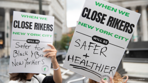 Protest signs outdoors that read 