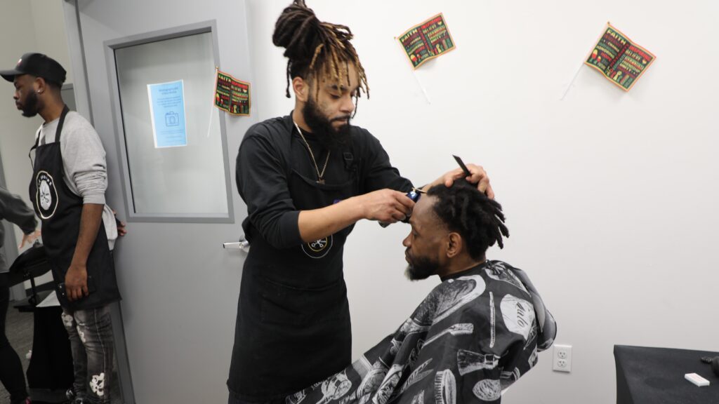 Barber giving man a haircut at our Staten Island Justice Center.