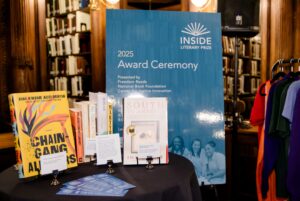 Several books on display on a table in front of a poster that reads "Inside Literary Prize 2025 Award Ceremony"