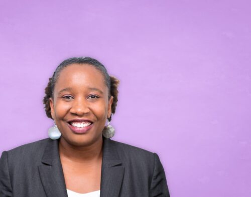 Aisha Greene smiling headshot.